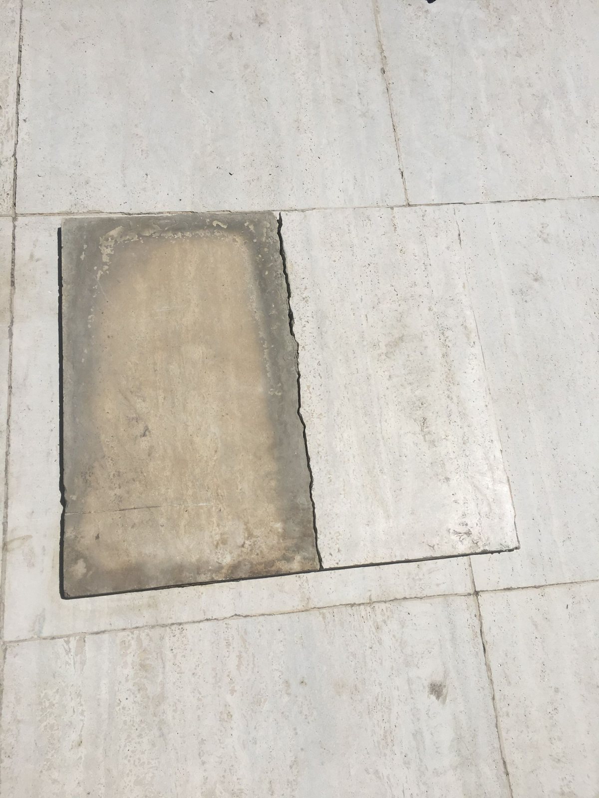 Travertine floor — one tile left as a control.